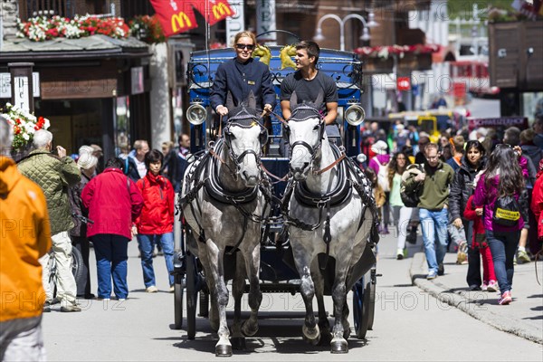 Horse-drawn carriage in Zermatter Bahnhofstrasse street