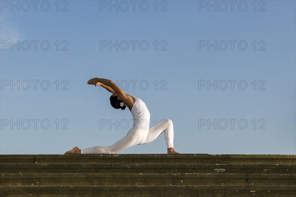 Young woman practising Hatha yoga