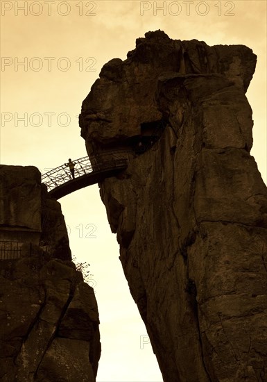 Person standing on a bridge