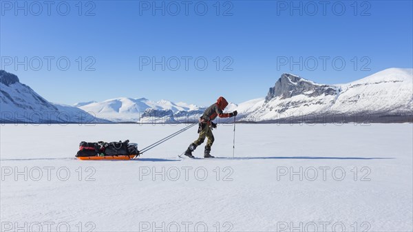 Ski tourers with Pulka in the snow