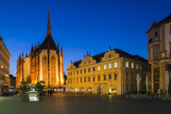 The illuminated Falkenhaus building and the Marienkapelle church