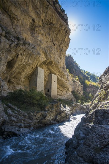 Chechen watchtowers under overhanging cliff on the Argun river