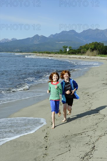 Children running on the beach on the east coast
