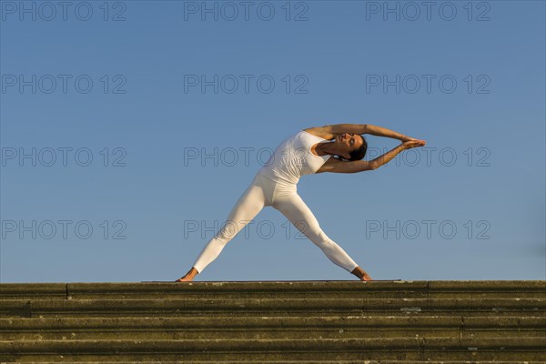 Young woman practising Hatha yoga