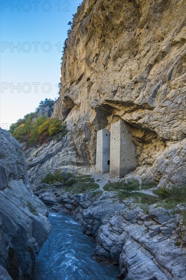 Chechen watchtowers under overhanging cliff on the Argun river