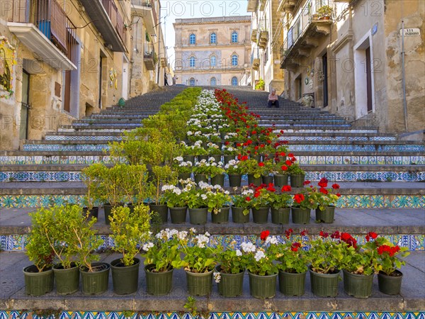 The Santa Maria del Monte staircase with ceramic tiles and potted plants