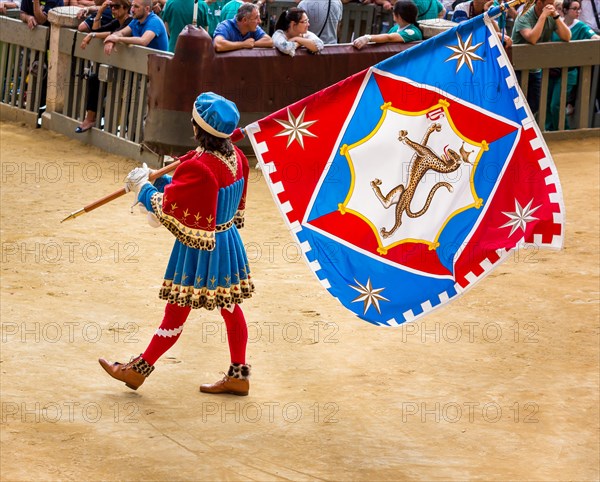 Man carrying a flag from the Pantheress contrade