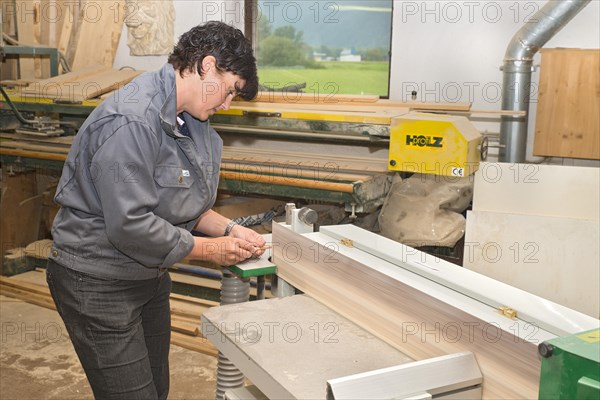 Young farmer repairing a hay rake