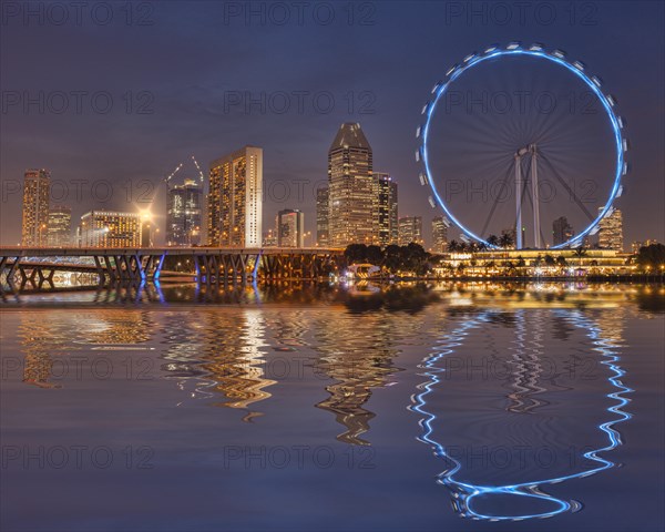 Singapore Flyer and Skyline reflected in the waters of Marina Bay