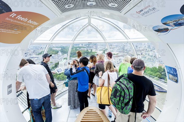 Tourists in a gondola of the Millennium Wheel London Eye