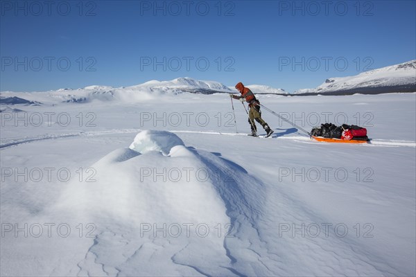 Ski tourers with Pulka in the snow