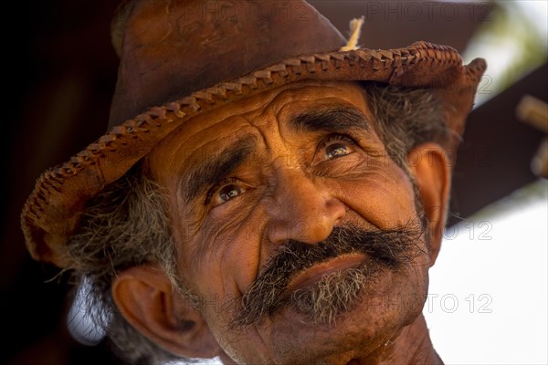 Sugar cane farmer wearing a hat