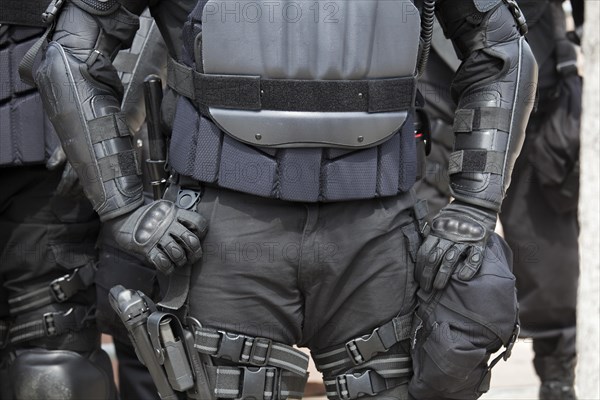 Police in riot gear protecting members of the neo-Nazi National Socialist Movement as they hold a rally on the steps of the government office building