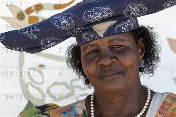 Local Herero woman wearing typical headdress and dress