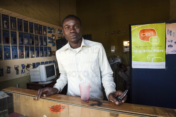 Local salesman in a small shop