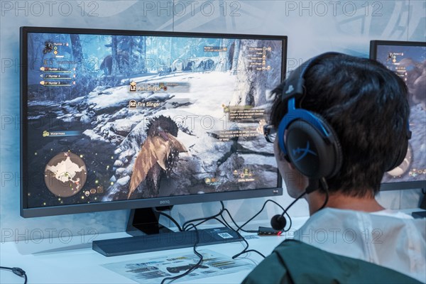 Visitors play the game Monsterhunter World Iceborne at gamescom