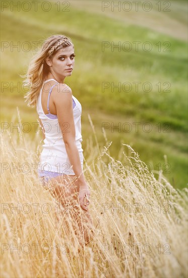 Young woman in lingerie posing outdoors