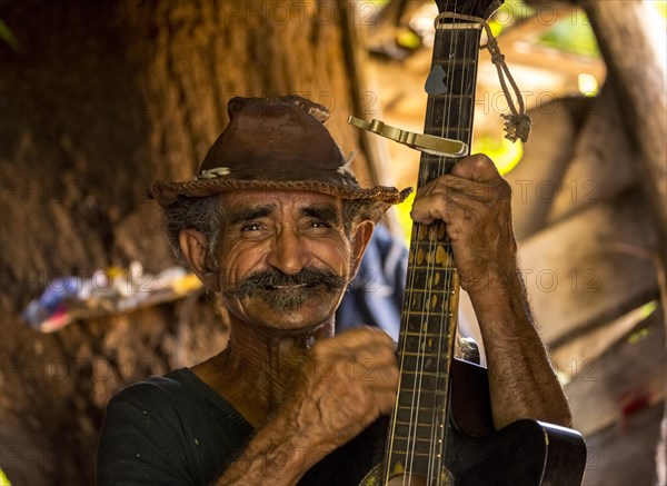 Sugar cane farmer playing the guitar