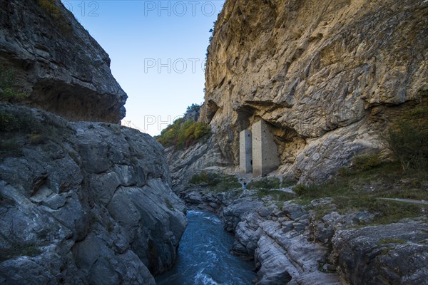 Chechen watchtowers under overhanging cliff on the Argun river