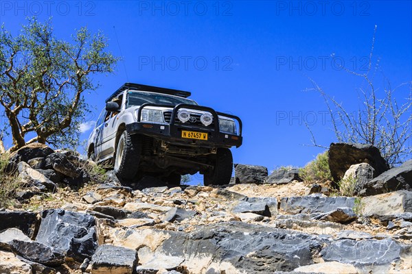 SUV driving down rock steps