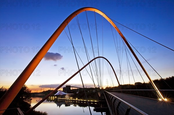 Illuminated double arch bridge over the Rhine-Herne Canal