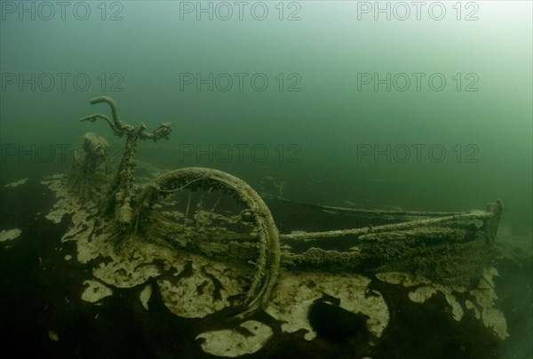 Rowing boat wreck with sunken bike