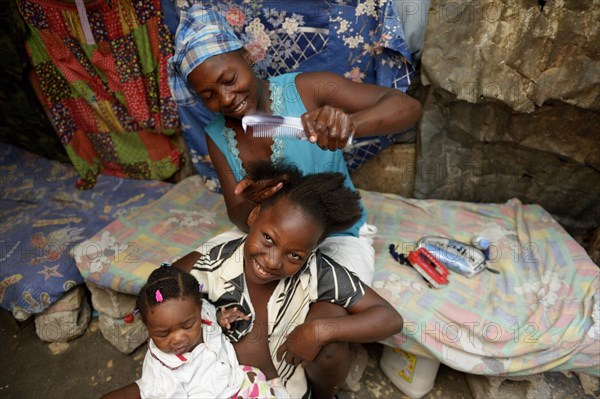 Mother braiding in her daughter's hair