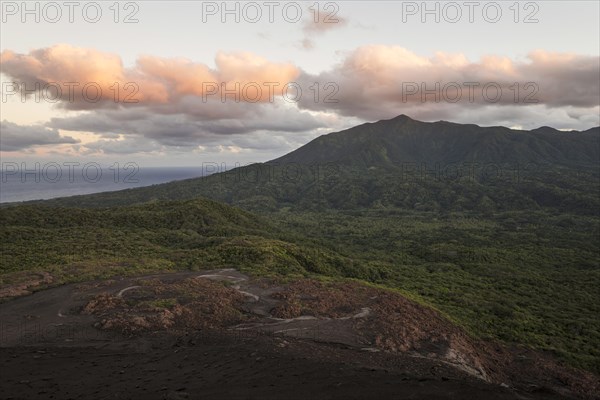 View from the crater of Mount Yasur volcano onto the sea in the morning light