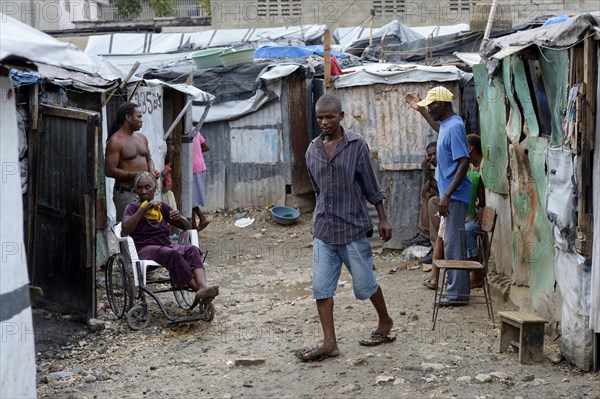 People and a sick woman in a wheelchair