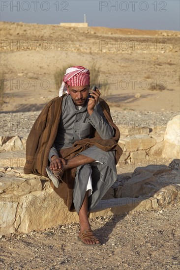 Jordanian in traditional dress on a mobile phone