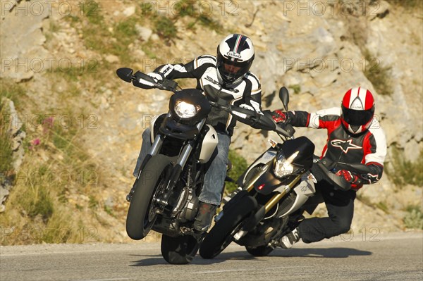 Two Motorcycles driving on the road