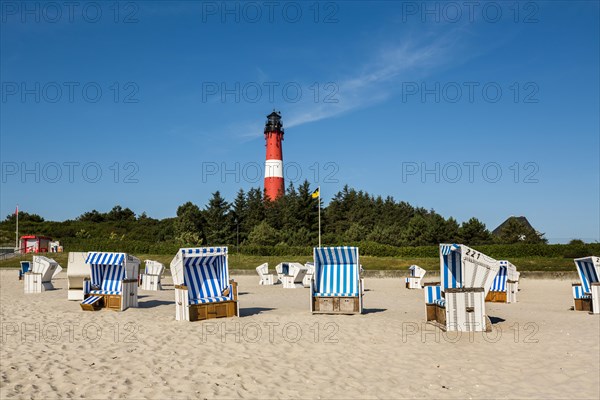 Beach chairs on the beach in front of the lighthouse