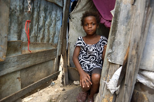 Girl in the entrance of a shack