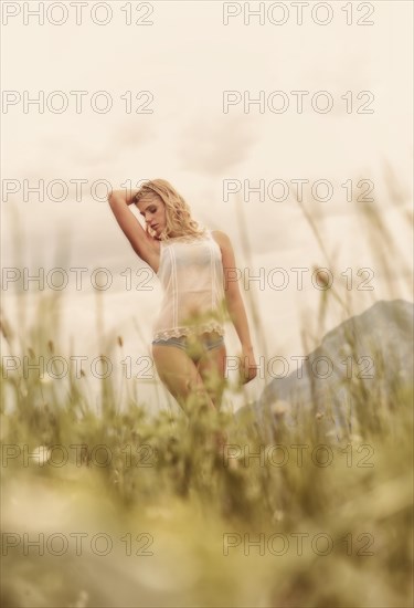 Young woman in lingerie posing outdoors