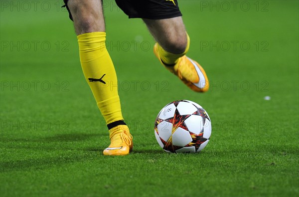 Legs of a BVB player with adidas Champions League Ball