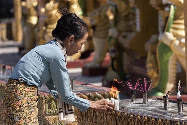 Local woman lighting candles