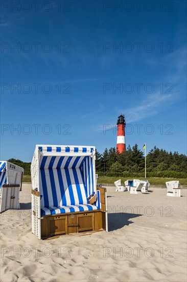 Beach chair on the beach in front of the lighthouse