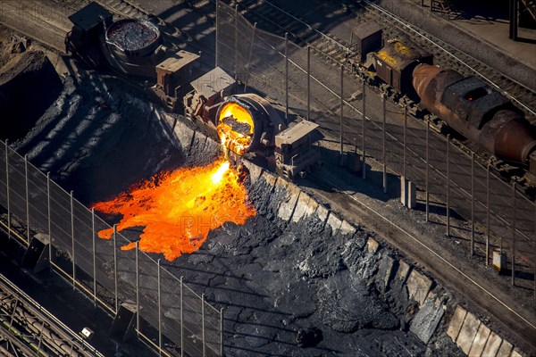 Hot iron production slag being poured from a barrel into a pit in the steel mill TKS ThyssenKrupp Steel