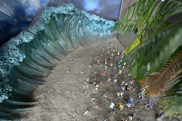 Model of the tsunami and people fleeing from the beach
