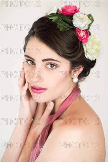 Beauty portrait of a young woman with flowers in her hair