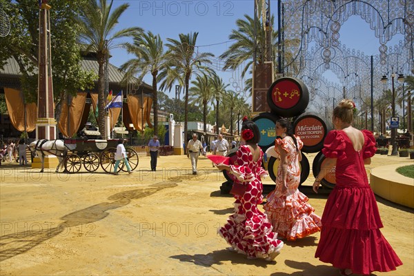 Women in flamenco dresses at the Feria del Caballo