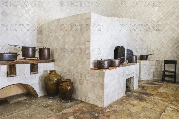 Copper utensils in vintage kitchen with baking stove