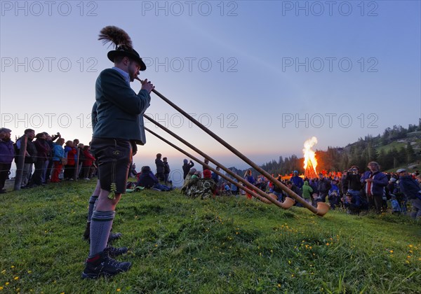 Alphorn players and bonfires