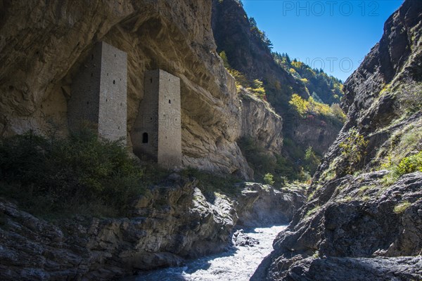 Chechen watchtowers under overhanging cliff on the Argun river