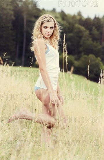 Young woman in lingerie posing outdoors