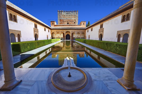 Arabesque Moorish architecture and pond of the Court of the Myrtles of the Palacios Nazaries