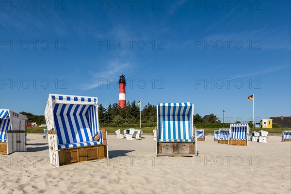 Beach chairs on the beach in front of the lighthouse