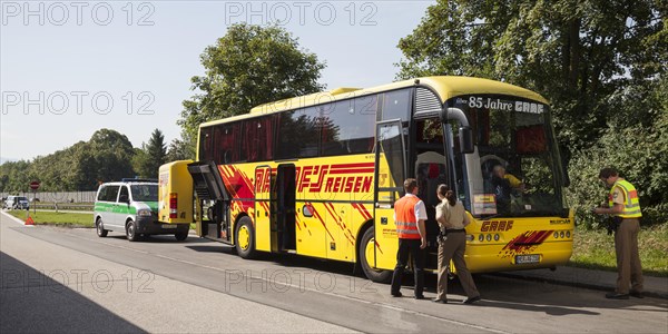 Police checking a coach on a motorway car park