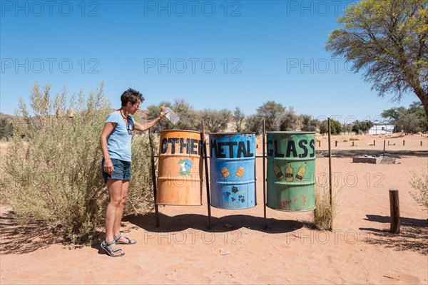 Tourist disposing of rubbish on a campsite