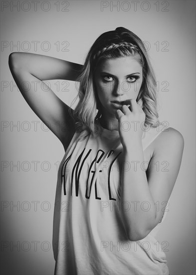 Young woman wearing a top with the word ""angel""